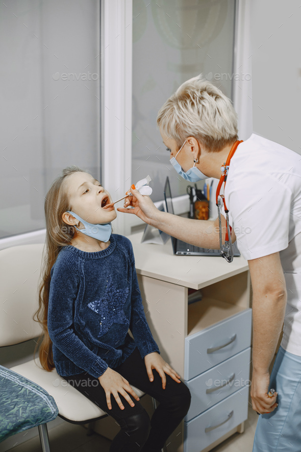 Little girl and the doctor for a checkup examined stock